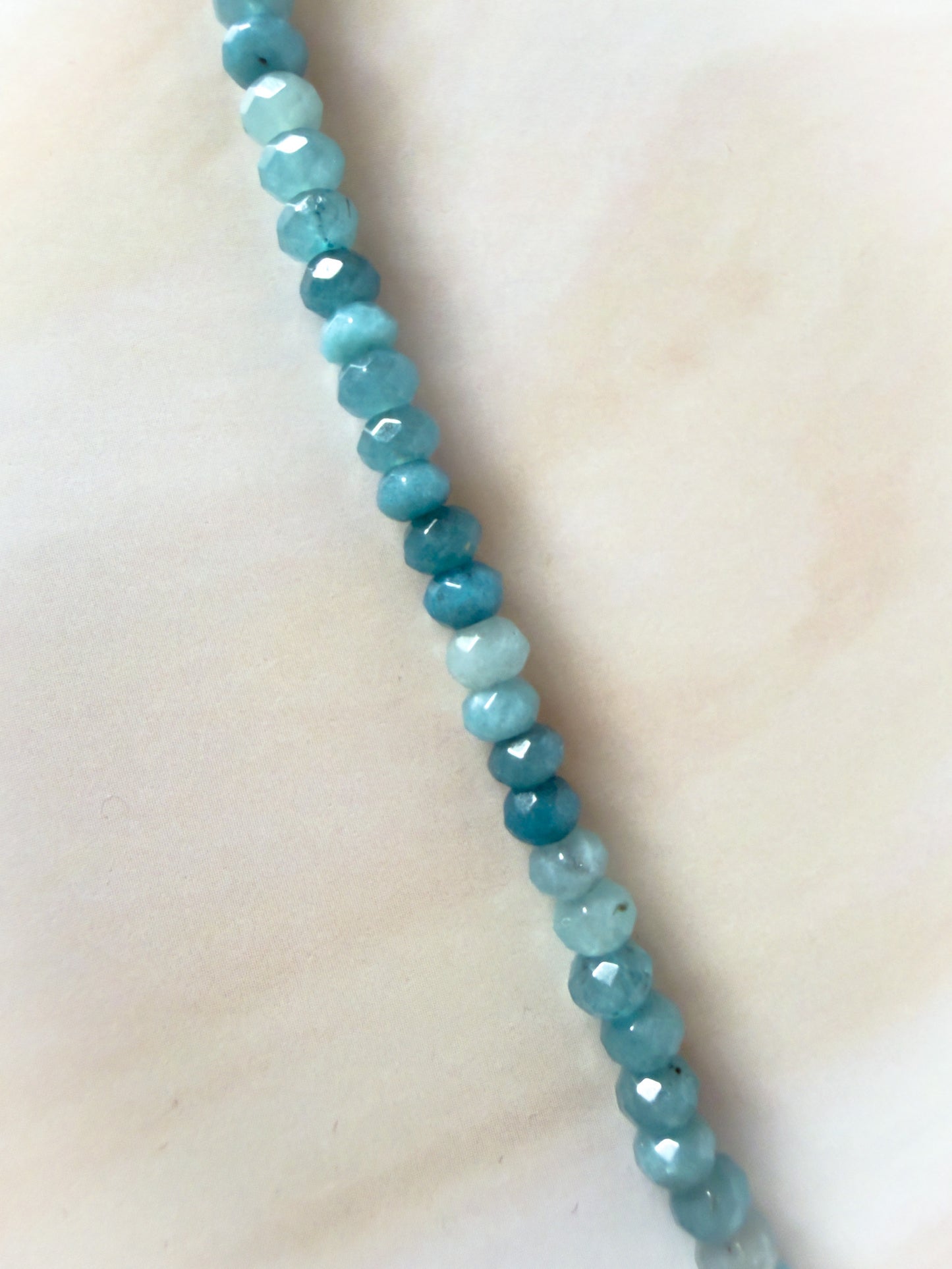 Necklace with blue beads on a light background