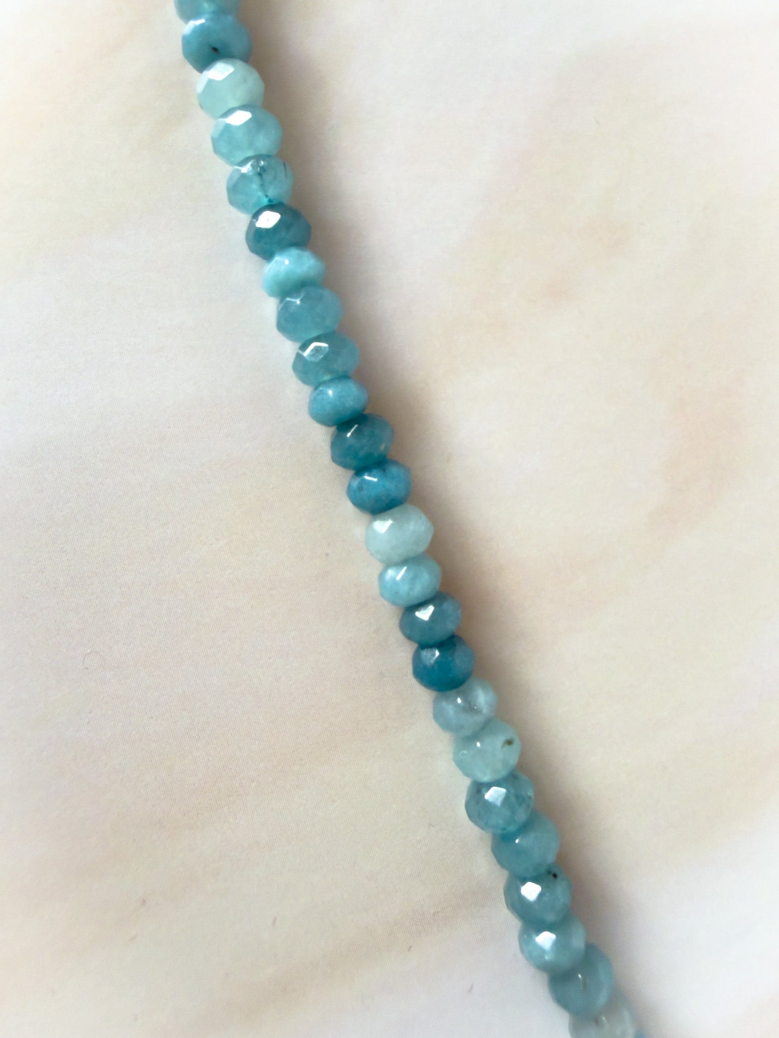 Necklace with blue beads on a light background