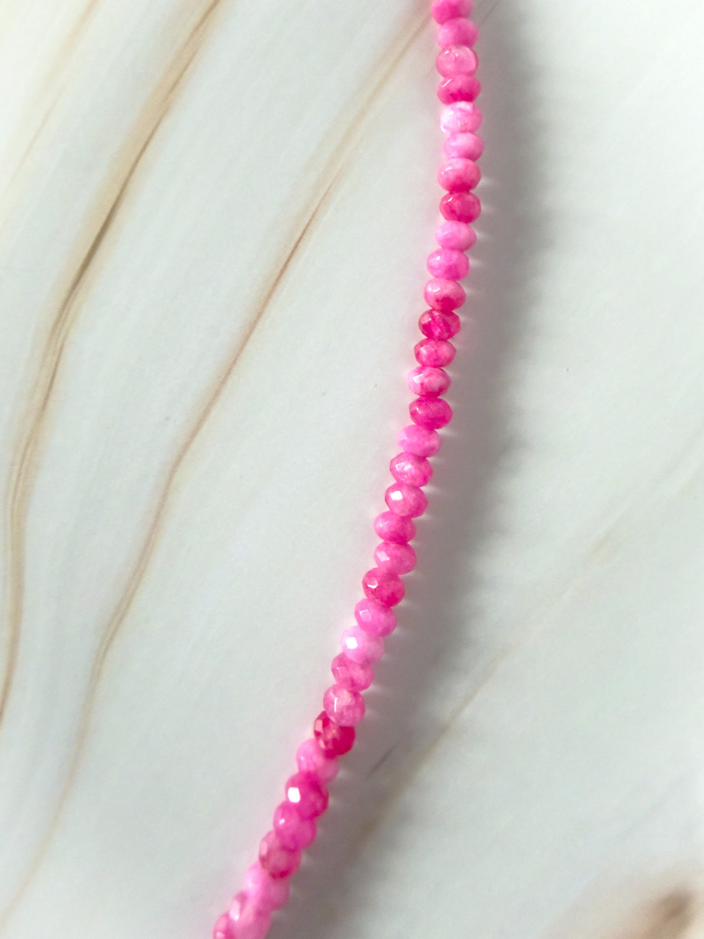 Necklace with pink beads on a light background