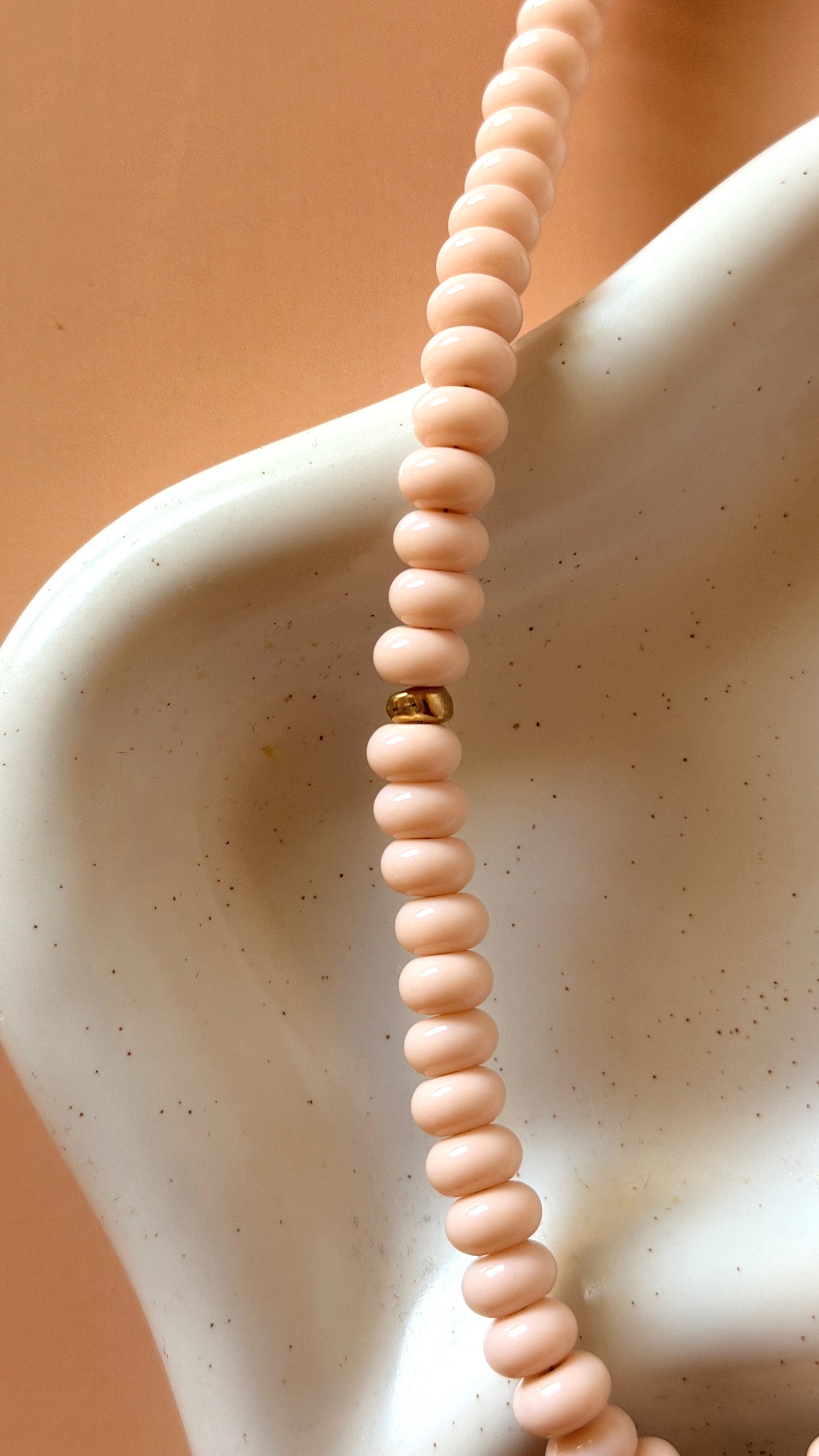 glass rondelle beaded necklace in blush color with gold accent beads